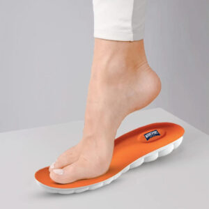 Foot stepping on an orange orthotic insole for arch support.