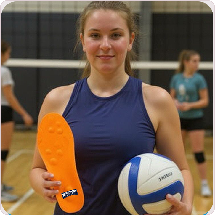 A volleyball player holding a ball and an orange shoe sole indoors.